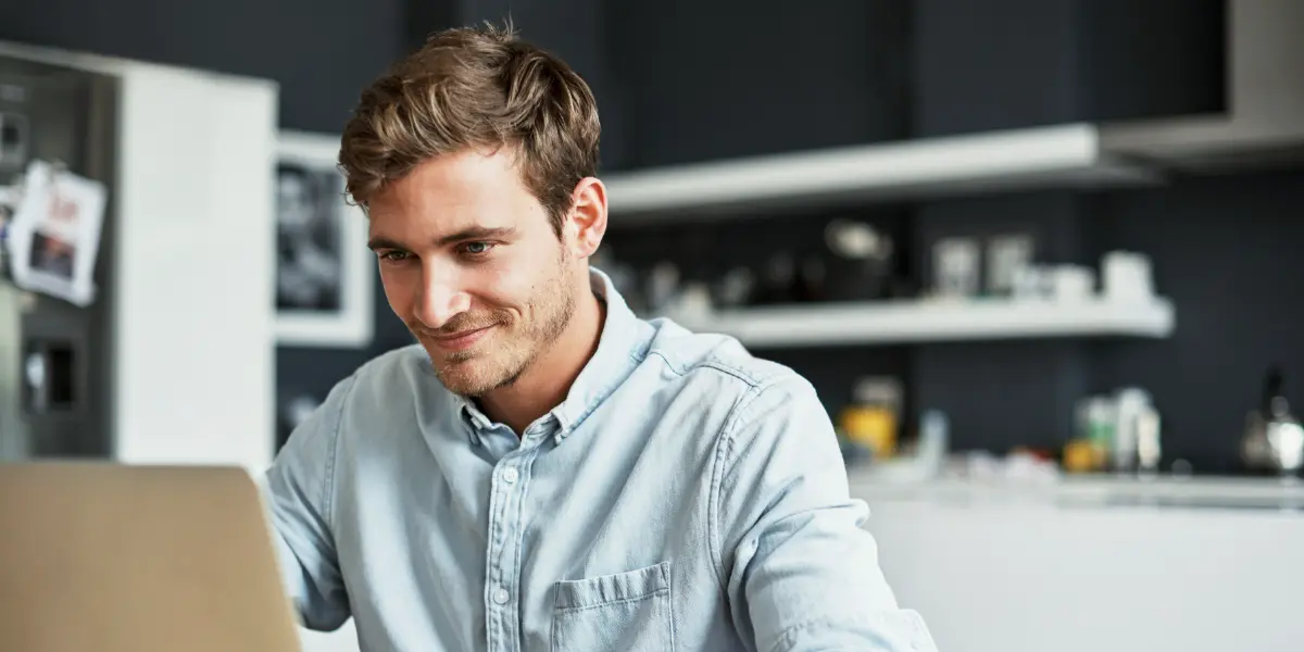 Man werkt thuis achter zijn laptop aan de eettafel